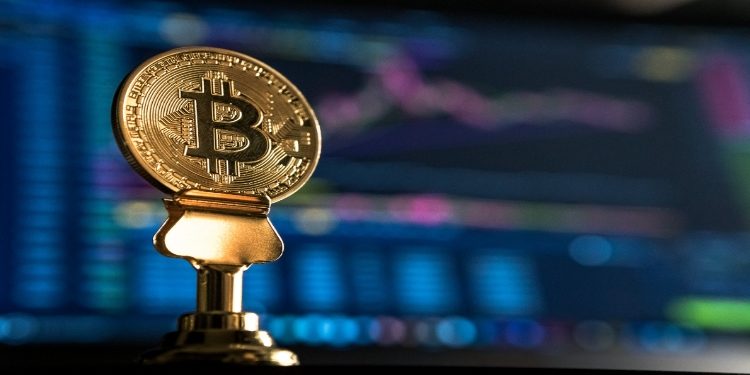 Bitcoin Commemorative Coin with a laptop screen back drop
