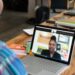 Two colleagues engage in a focused virtual meeting, discussing strategies for implementing knowledge management to enhance efficiency within a manufacturing company.