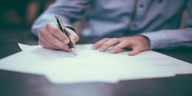 Man signing an insurance