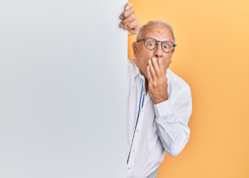 A man peeking behind a wall