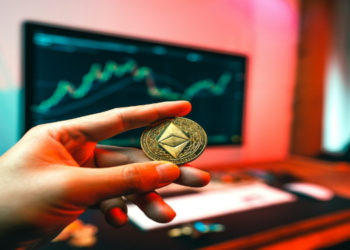 Hand holding an Ethereum coin