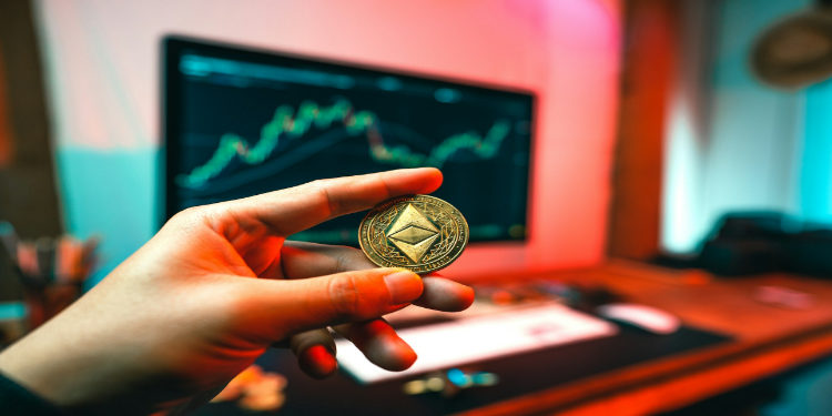 Hand holding an Ethereum coin