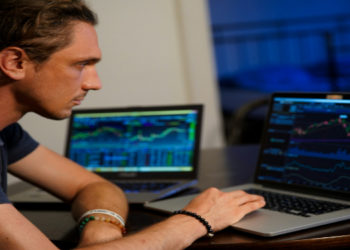 Man checking the Stock Market and Investment Graph