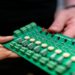 Engineer working on a circuit board for sustainable solutions