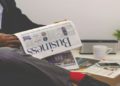 Entrepreneur reading a business newspaper