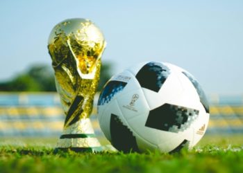 Soccer ball and a world cup throphy