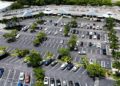 Aerial view of a parking lot with different parked cars