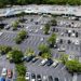 Aerial view of a parking lot with different parked cars