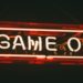 Bright neon sign reading "Game On," illuminating the surrounding area with vibrant colors.