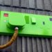Exterior view of a green electrical outlet