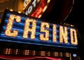 Neon-lit casino sign featuring vibrant red lights, showcasing the excitement of gaming and entertainment.