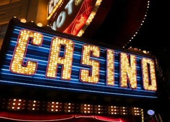 Neon-lit casino sign featuring vibrant red lights, showcasing the excitement of gaming and entertainment.