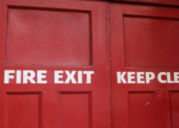Red door labeled "Fire Exit Keep Clear," indicating it should remain unobstructed for safety.