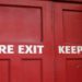 Red door labeled "Fire Exit Keep Clear," indicating it should remain unobstructed for safety.
