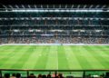 Crowded soccer stadium filled with spectators watching an exciting game unfold on the field.