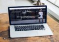 Laptop placed on a wooden table, featured in a blog about technology and workspace setups.