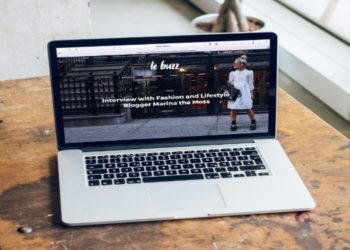 Laptop placed on a wooden table, featured in a blog about technology and workspace setups.