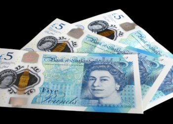 Three overlapping UK £5 notes on a black background, each featuring a portrait of a woman, intricate designs, and blue-toned colors, conveying currency theme.