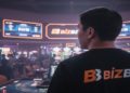 Person wearing a "BizBet" shirt stands in a lively casino. Bright slot machines and digital displays create an energetic, bustling atmosphere.