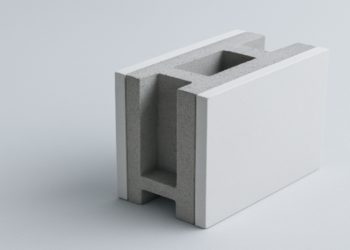 White, rectangular concrete block with a hollow center rests on a light gray surface. The modern design conveys simplicity and functionality.
