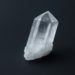 Clear quartz crystal with sharp, faceted edges stands upright against a dark background, conveying a sense of clarity and serenity.