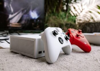 Game controllers and console in front of a TV