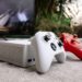 Game controllers and console in front of a TV