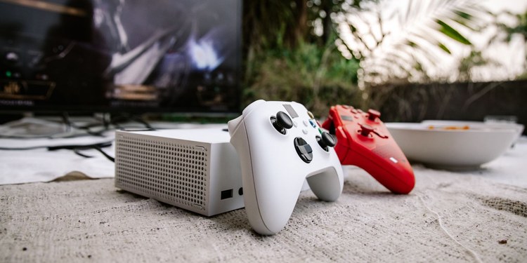 Game controllers and console in front of a TV