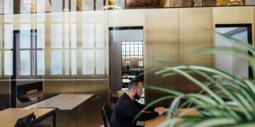Man working on a laptop in an open office space